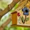 Glitzhome® 10.5" Yellow Distressed Wood Birdhouse with Flowers
